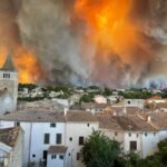Firefighters battle a massive wildfire in southern France as thick smoke engulfs forests and authorities evacuate more than 200,000 residents and tourists.