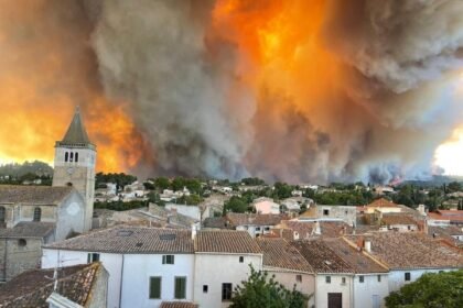 Firefighters battle a massive wildfire in southern France as thick smoke engulfs forests and authorities evacuate more than 200,000 residents and tourists.